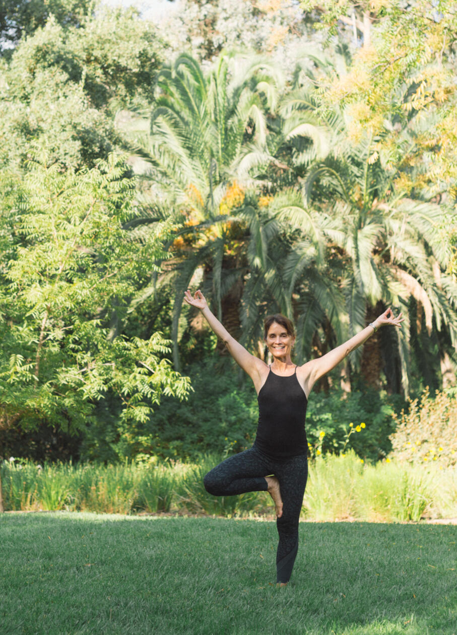 Woman doing a yoga pose in a field